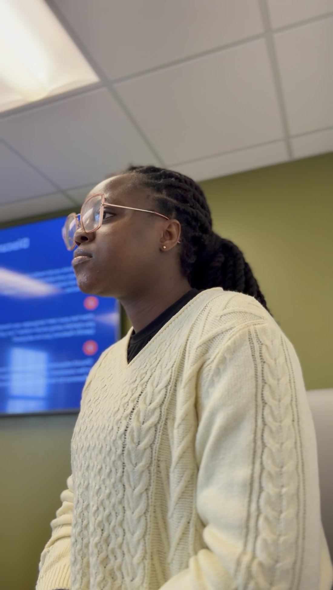 Wemimo teaching in front of a classroom screen